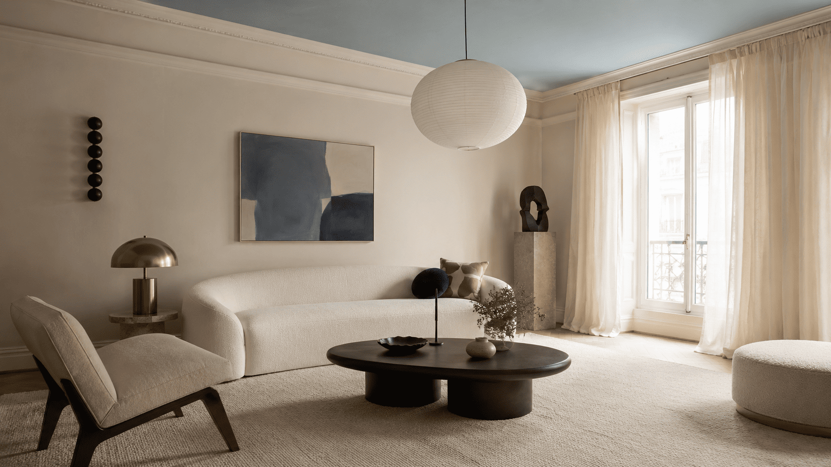 Salon contemporain avec plafond peint en teinte douce, canapé arrondi et décoration actuelle.