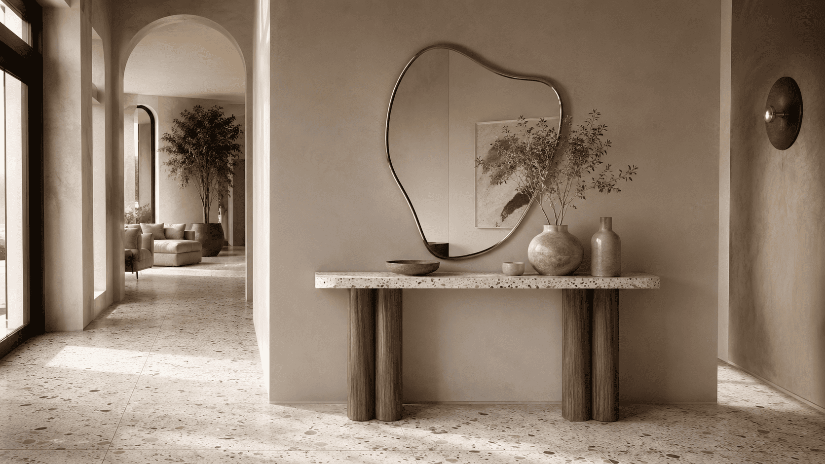 Salle de bain ou entrée contemporaine avec touches de terrazzo, miroir organique et accessoires sobres.